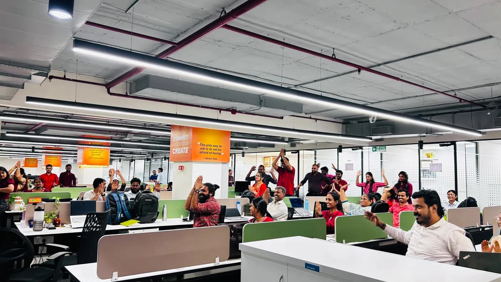 Quess Corp employees doing a guided desk stretch break at their workstations